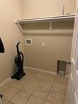 817 NW Evans Cir, Bentonville, AR 72712 - washroom with tile patterned floors, laundry area, and washer hookup