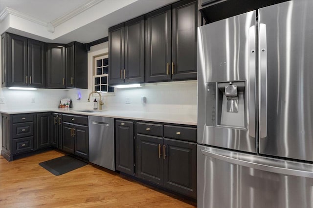 2111 Sycamore Dr, West Plains, MO 65775 - kitchen with a sink, ornamental molding, tasteful backsplash, and appliances with stainless steel finishes