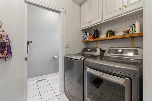 2111 Sycamore Dr, West Plains, MO 65775 - laundry area featuring washer and dryer, visible vents, light tile patterned floors, and cabinet space