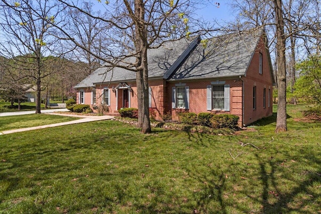 2111 Sycamore Dr, West Plains, MO 65775 - cape cod-style house with a front lawn and brick siding