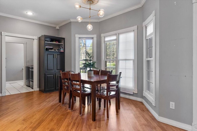 2111 Sycamore Dr, West Plains, MO 65775 - dining room featuring crown molding, baseboards, light wood-type flooring, and an inviting chandelier