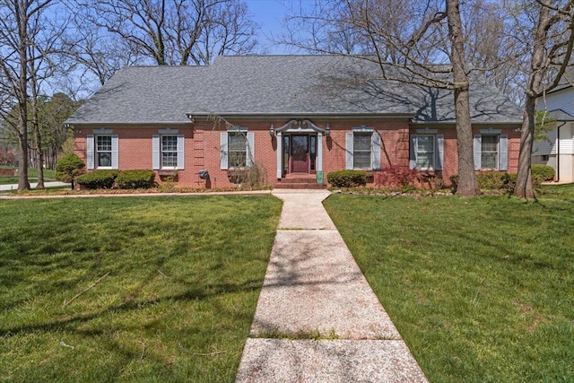 2111 Sycamore Dr, West Plains, MO 65775 - view of front facade featuring roof with shingles, a front yard, and brick siding
