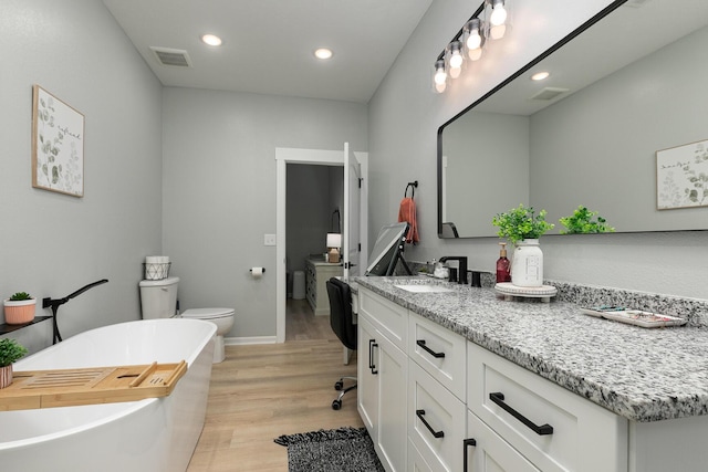 1798 E 328th Rd, Bolivar, MO 65613 - bathroom with visible vents, a freestanding bath, toilet, vanity, and wood finished floors