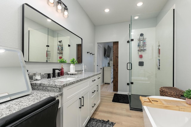 1798 E 328th Rd, Bolivar, MO 65613 - bathroom with a freestanding tub, vanity, recessed lighting, a shower stall, and wood finished floors