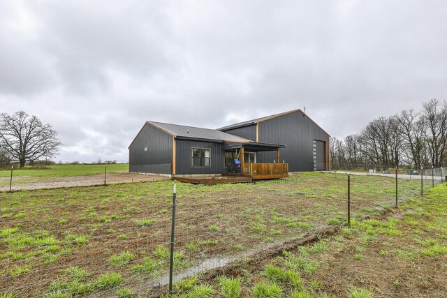 1798 E 328th Rd, Bolivar, MO 65613 - rear view of house featuring a garage, an outdoor structure, fence, and an outbuilding