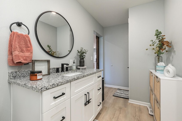 1798 E 328th Rd, Bolivar, MO 65613 - bathroom with wood finished floors, vanity, and baseboards