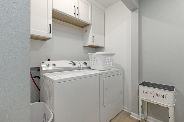 1798 E 328th Rd, Bolivar, MO 65613 - clothes washing area featuring cabinet space, washer and clothes dryer, light wood-type flooring, and baseboards