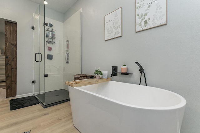 1798 E 328th Rd, Bolivar, MO 65613 - bathroom with a shower stall, a freestanding bath, and wood finished floors