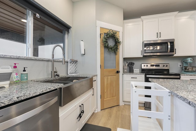 1798 E 328th Rd, Bolivar, MO 65613 - kitchen featuring a sink, white cabinets, appliances with stainless steel finishes, and light wood-style floors