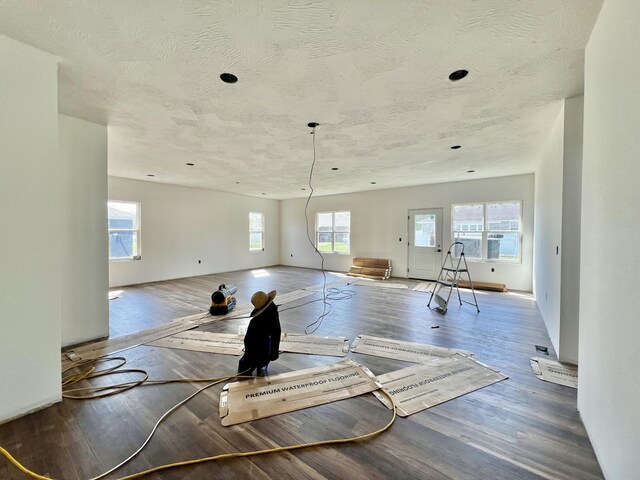 710 E Vivian St, Bolivar, MO 65613 - workout area with a wealth of natural light, a textured ceiling, and wood finished floors