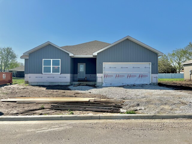 710 E Vivian St, Bolivar, MO 65613 - unfinished property featuring roof with shingles, a garage, and fence