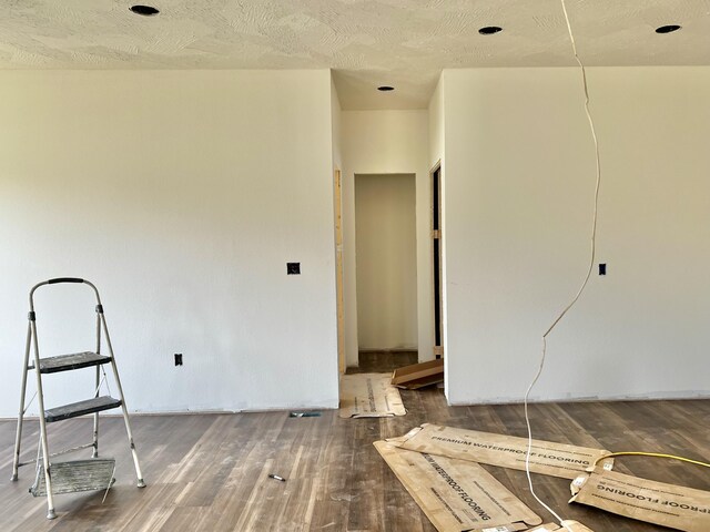710 E Vivian St, Bolivar, MO 65613 - empty room with a textured ceiling and wood finished floors