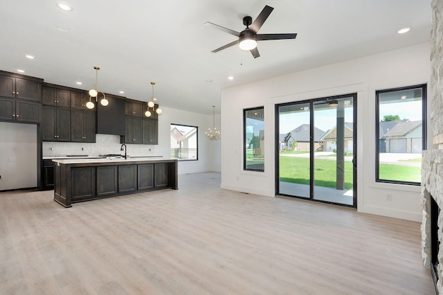 3021 W Allen Dr, Springfield, MO 65810 - kitchen with plenty of natural light, light wood finished floors, dark brown cabinets, and recessed lighting