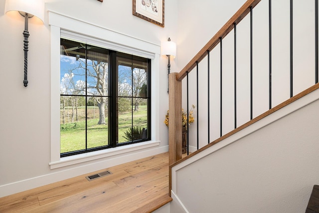interior space with visible vents, baseboards, and wood finished floors