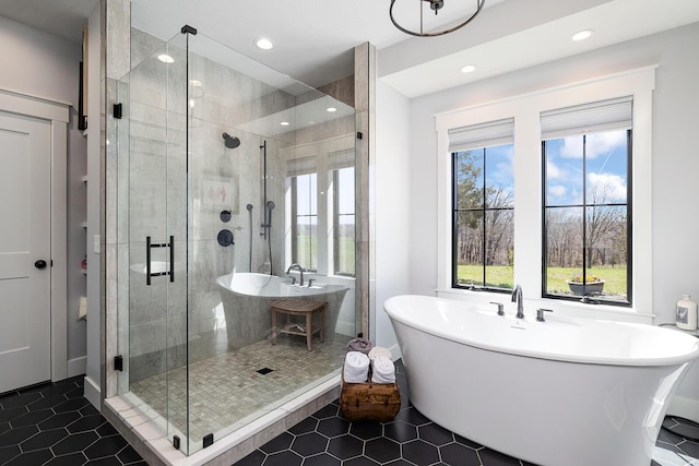 bathroom with a freestanding bath, tile patterned floors, a stall shower, and recessed lighting