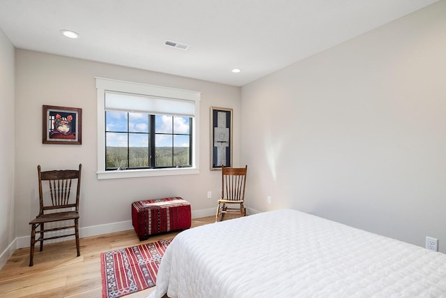 bedroom with visible vents, baseboards, light wood-type flooring, and recessed lighting