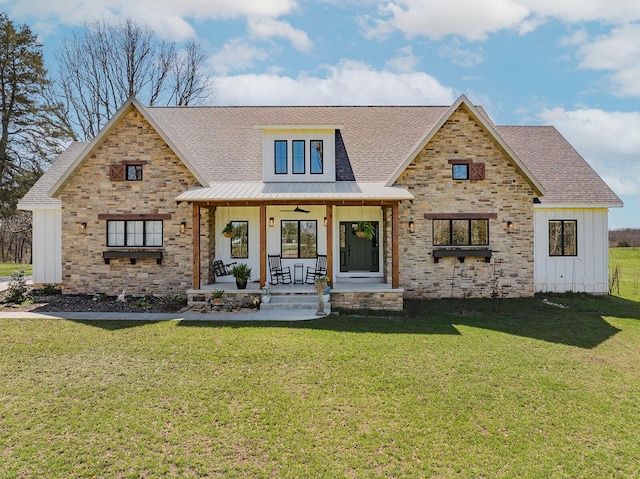 modern inspired farmhouse featuring a front yard, board and batten siding, stone siding, and covered porch
