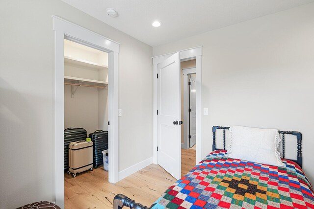 bedroom with recessed lighting, baseboards, and wood finished floors