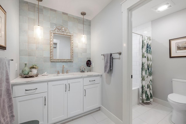 bathroom with vanity, visible vents, toilet, tile patterned floors, and shower / bath combo with shower curtain