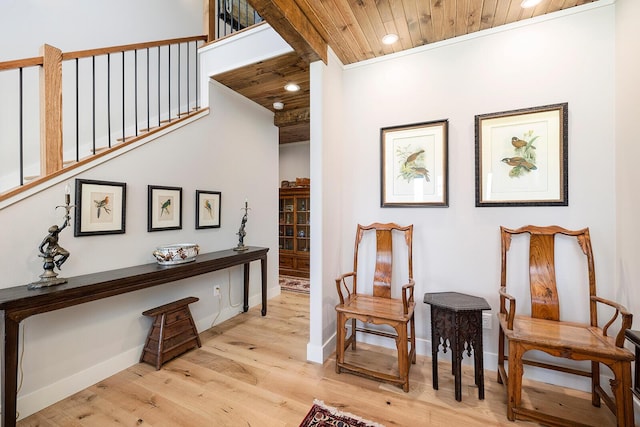 living area featuring light wood-style flooring, recessed lighting, baseboards, and wood ceiling