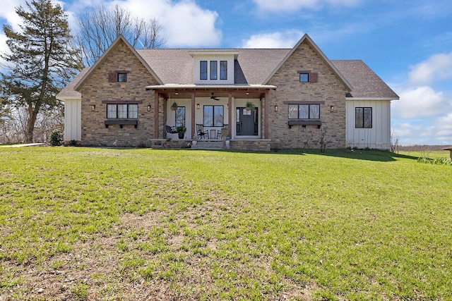 view of front of home featuring a porch, roof with shingles, board and batten siding, and a front yard