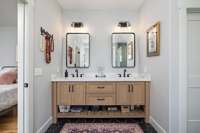 full bath with a sink, double vanity, connected bathroom, and tile patterned flooring