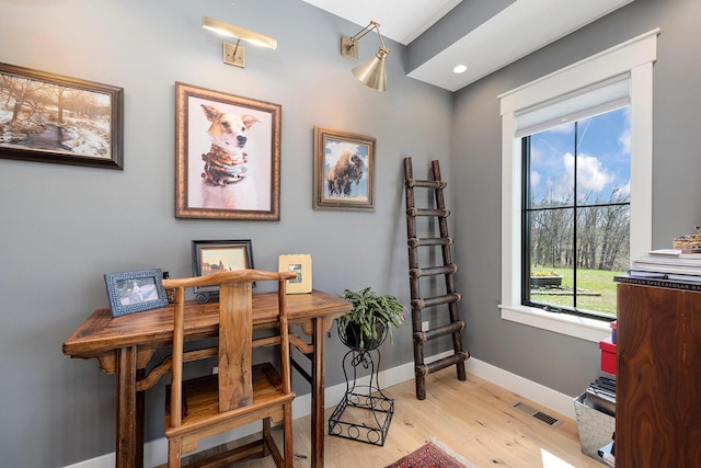 office space featuring recessed lighting, light wood-style floors, baseboards, and visible vents