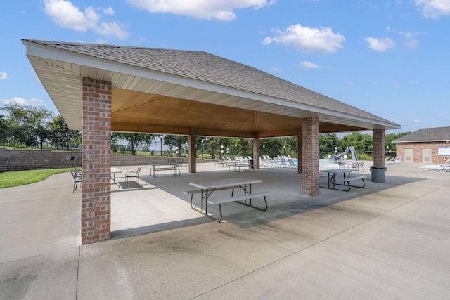 view of property's community with fence and a gazebo