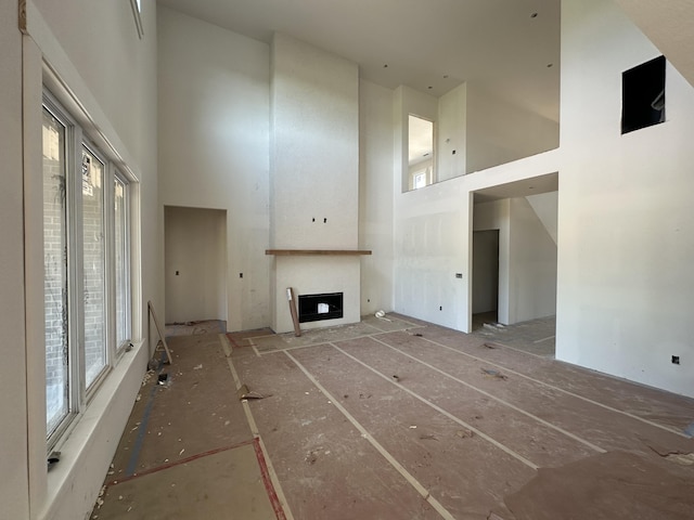 1798 E Cobblestone Dr, Ozark, MO 65721 - unfurnished living room with a towering ceiling and a fireplace