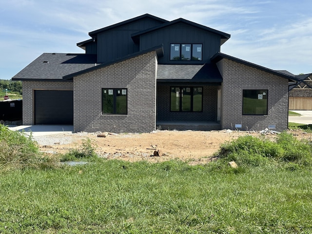 1798 E Cobblestone Dr, Ozark, MO 65721 - back of house with brick siding, a garage, board and batten siding, and driveway