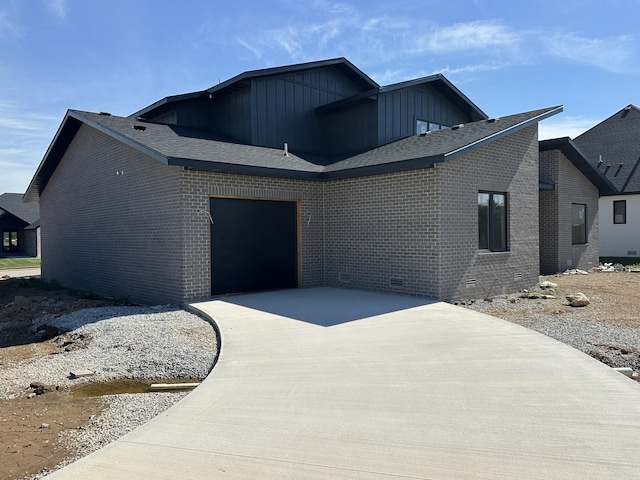 1798 E Cobblestone Dr, Ozark, MO 65721 - view of front of house featuring concrete driveway, a garage, board and batten siding, and brick siding