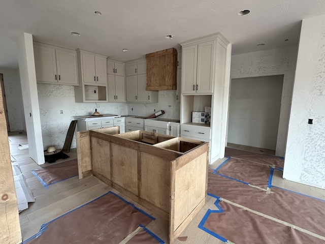 kitchen with a textured wall and a kitchen island