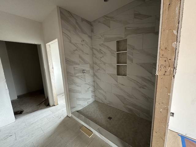 bathroom with tiled shower