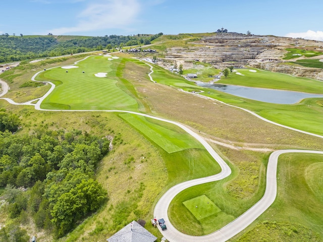 birds eye view of property featuring view of golf course and a water view