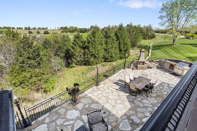 view of patio / terrace featuring fence and a fire pit