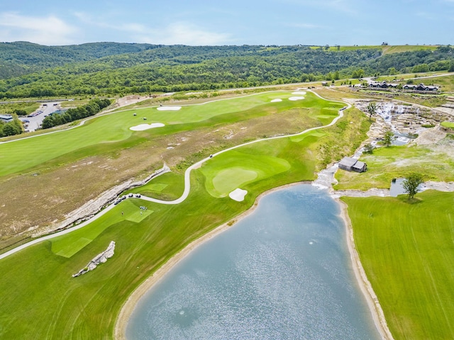bird's eye view with a water view, a view of trees, and view of golf course