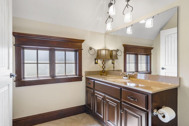 bathroom featuring tile patterned floors, vanity, and baseboards