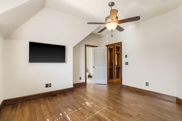 interior space with lofted ceiling, baseboards, a ceiling fan, and wood finished floors