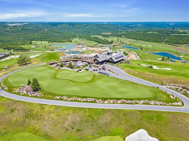 bird's eye view featuring a water view and golf course view