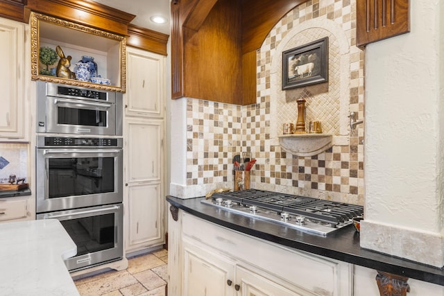 kitchen with open shelves, a textured wall, stone tile floors, stainless steel appliances, and decorative backsplash