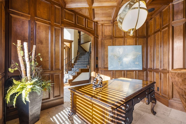 home office featuring wood walls, a decorative wall, arched walkways, and coffered ceiling
