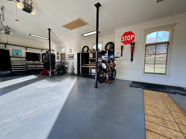 garage featuring a garage door opener and baseboards