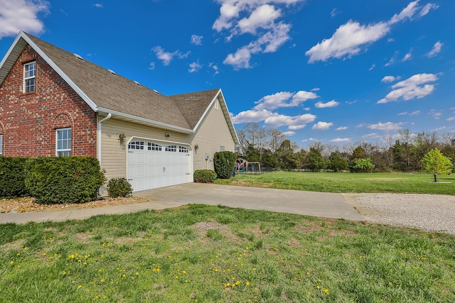 view of property exterior with roof with shingles, driveway, an attached garage, brick siding, and a lawn