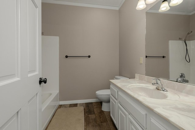 bathroom featuring vanity, crown molding, toilet, and wood finished floors