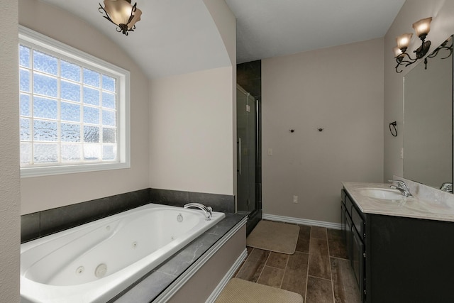 full bath with a tub with jets, wood tiled floor, a shower stall, vanity, and vaulted ceiling