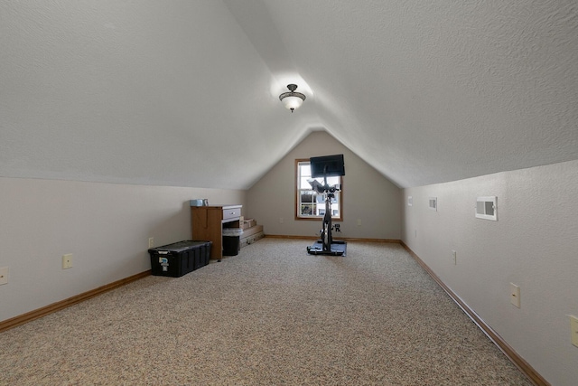 bonus room featuring a textured ceiling, visible vents, light carpet, lofted ceiling, and baseboards