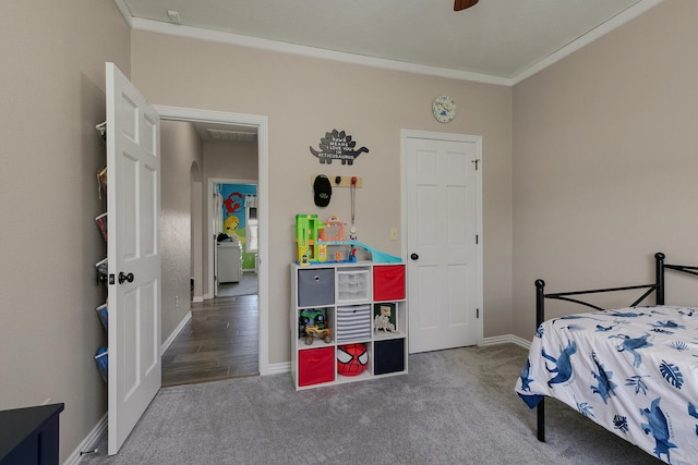 carpeted bedroom with ornamental molding and baseboards