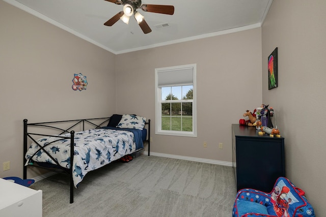 carpeted bedroom with ceiling fan, baseboards, ornamental molding, and visible vents