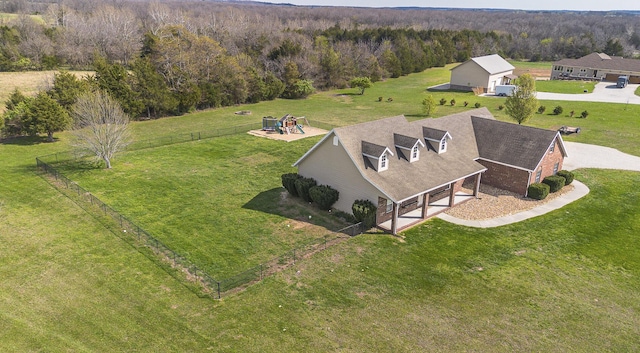 birds eye view of property with a view of trees