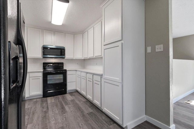 1945 Debra Dr, West Plains, MO 65775 - kitchen featuring tasteful backsplash, light countertops, a textured ceiling, dark wood-type flooring, and black appliances